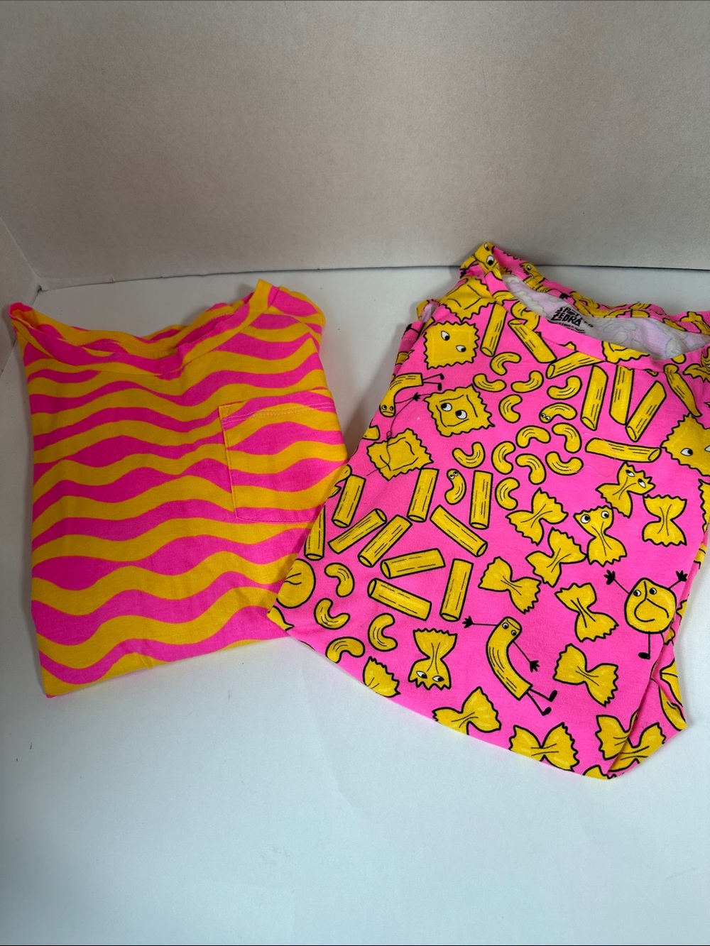 Spotted zebra bundle of 2 pink and yellow peplum shirts size 12